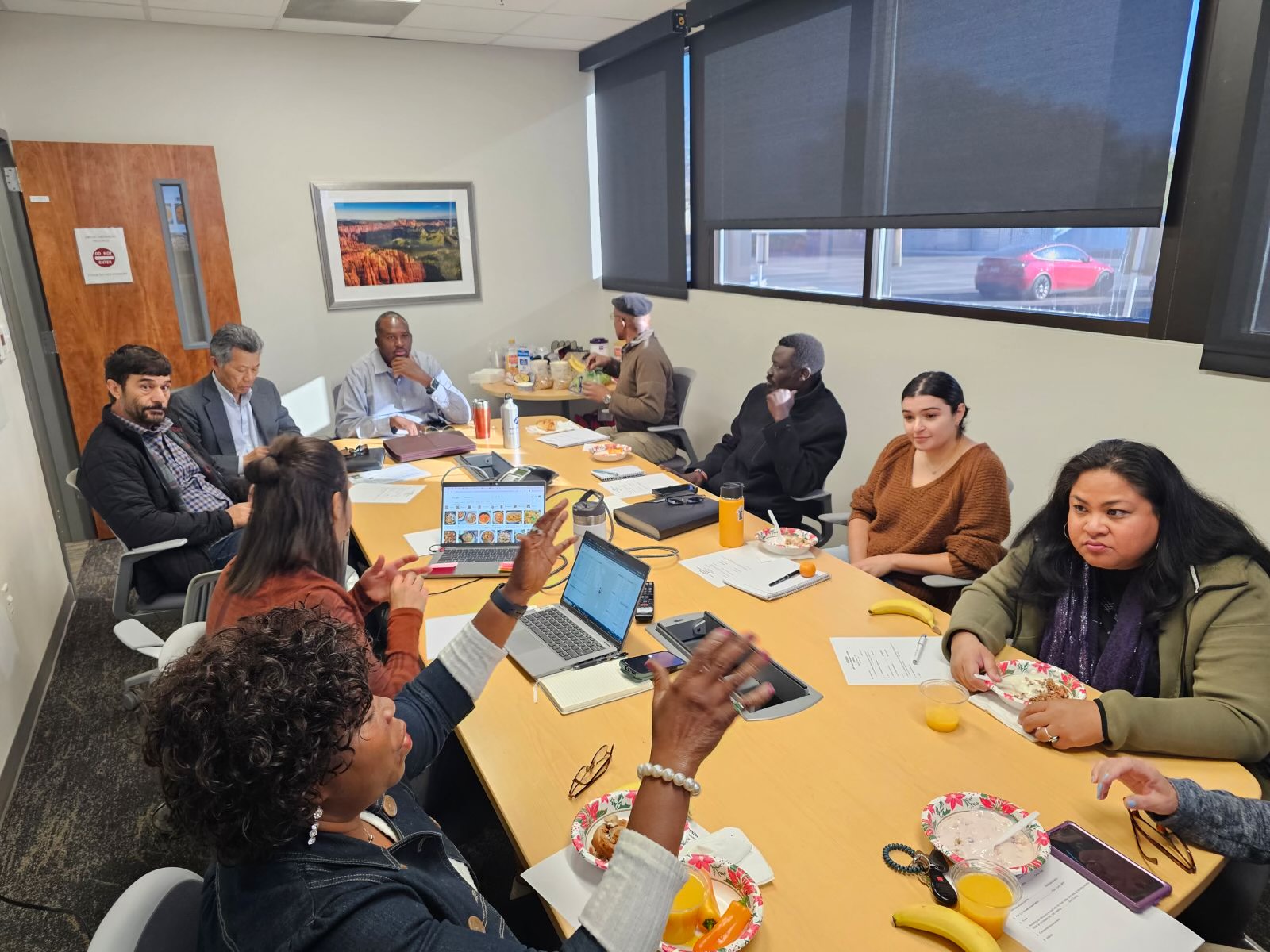 Refugees discussing work at a table